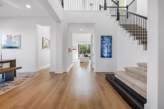 4612 Destination Way, Jonestown, TX 78645 - entrance foyer featuring stairs, wood finished floors, recessed lighting, and a high ceiling