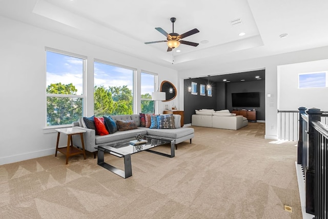 4612 Destination Way, Jonestown, TX 78645 - carpeted living area featuring a tray ceiling and a ceiling fan