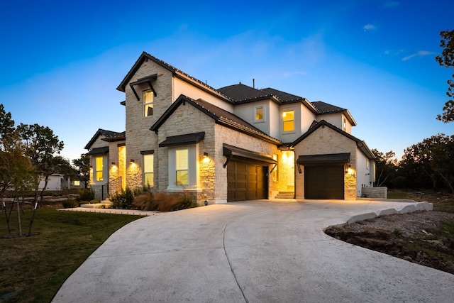 4612 Destination Way, Jonestown, TX 78645 - view of front of house featuring stone siding, an attached garage, concrete driveway, and stucco siding