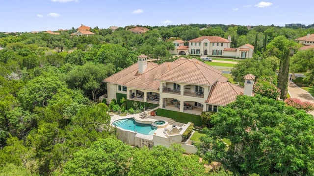 117 Bella Cima Dr, Austin, TX 78734 - back of house featuring a balcony, a chimney, a tiled roof, a patio, and a pool with connected hot tub