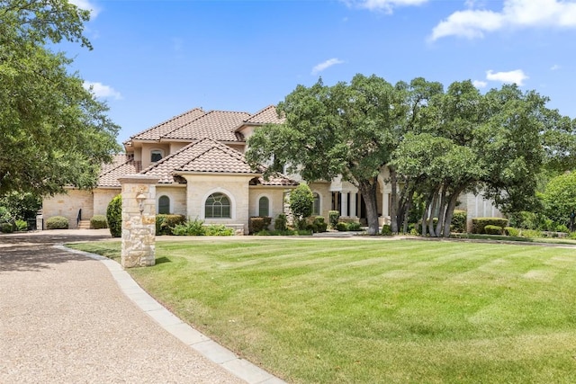 117 Bella Cima Dr, Austin, TX 78734 - mediterranean / spanish-style home with a tile roof, stone siding, stucco siding, and a front yard