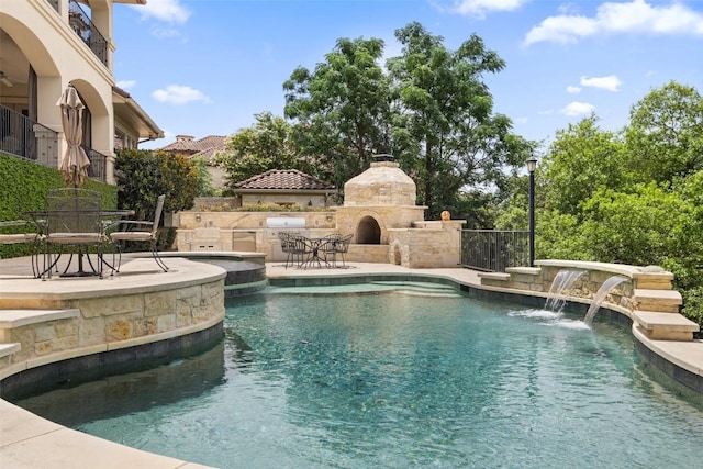 117 Bella Cima Dr, Austin, TX 78734 - swimming pool featuring an outdoor stone fireplace, a patio, and an outdoor kitchen