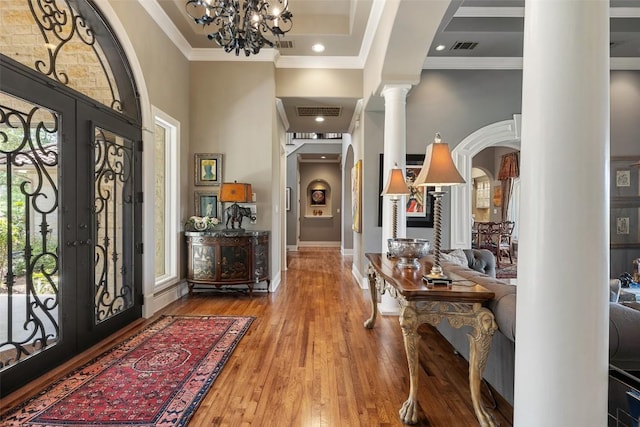 117 Bella Cima Dr, Austin, TX 78734 - foyer featuring decorative columns, a high ceiling, arched walkways, ornamental molding, and a chandelier