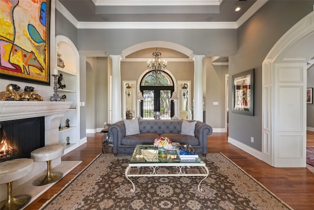 117 Bella Cima Dr, Austin, TX 78734 - living area featuring ornate columns, dark wood-style flooring, built in features, a premium fireplace, and crown molding