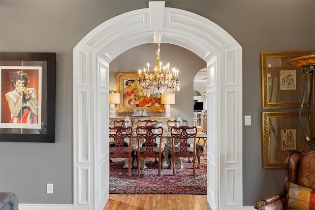 117 Bella Cima Dr, Austin, TX 78734 - dining space with arched walkways, a chandelier, and light wood-style floors