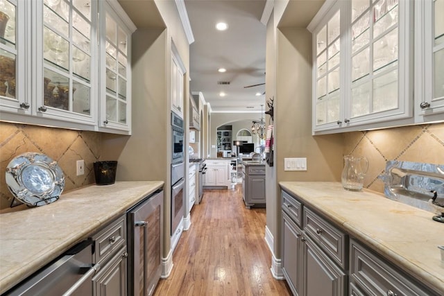 117 Bella Cima Dr, Austin, TX 78734 - kitchen with beverage cooler, light countertops, decorative backsplash, white cabinets, and recessed lighting