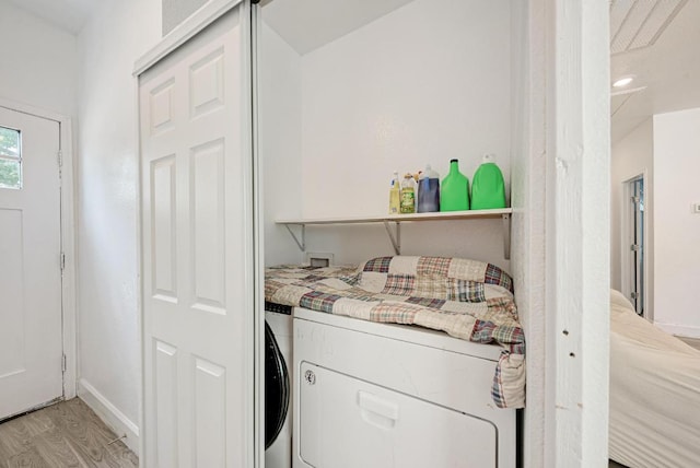 114 Crepe Myrtle Pkwy, Elgin, TX 78621 - washroom with washer and clothes dryer and light wood-style flooring