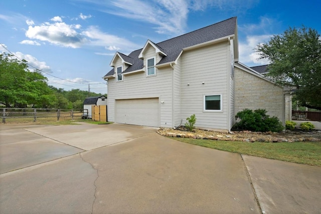 13410 Saddle Back Pass, Austin, TX 78738 - view of side of home with concrete driveway, an attached garage, and a shingled roof