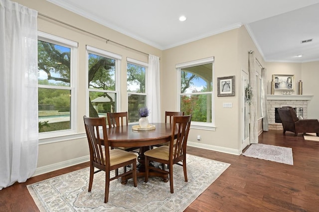 13410 Saddle Back Pass, Austin, TX 78738 - dining space featuring ornamental molding, dark wood finished floors, recessed lighting, and a fireplace