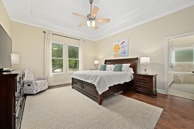 13410 Saddle Back Pass, Austin, TX 78738 - bedroom featuring dark wood-style floors, a raised ceiling, crown molding, a ceiling fan, and connected bathroom