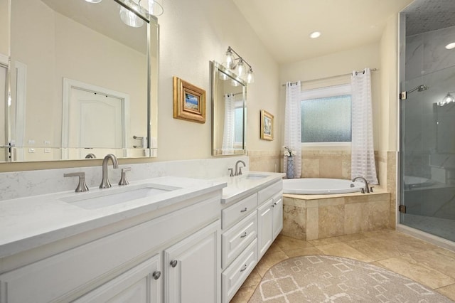 13410 Saddle Back Pass, Austin, TX 78738 - bathroom featuring double vanity, a shower stall, a garden tub, and tile patterned flooring