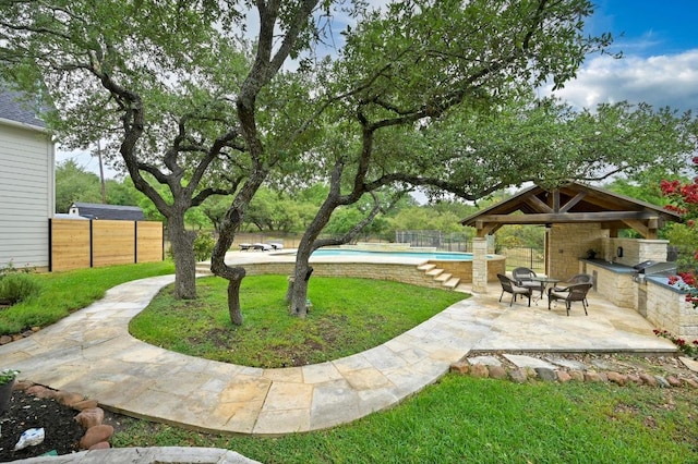 13410 Saddle Back Pass, Austin, TX 78738 - fenced backyard featuring exterior kitchen, a patio, and a gazebo
