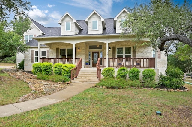 13410 Saddle Back Pass, Austin, TX 78738 - view of front of home with stone siding, covered porch, a front lawn, and a shingled roof