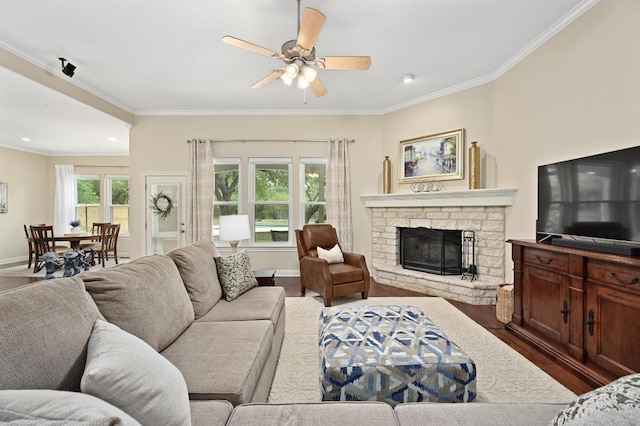 13410 Saddle Back Pass, Austin, TX 78738 - living area with crown molding, dark wood-style flooring, ceiling fan, a stone fireplace, and recessed lighting