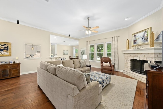 13410 Saddle Back Pass, Austin, TX 78738 - living room featuring crown molding, dark wood-type flooring, a ceiling fan, a stone fireplace, and recessed lighting