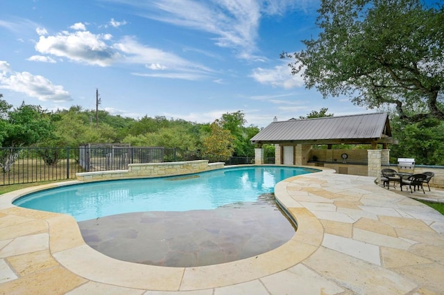 13410 Saddle Back Pass, Austin, TX 78738 - view of swimming pool featuring a patio and an outdoor kitchen