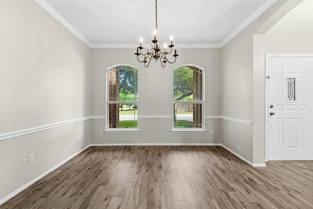 1612 Cora Marie Dr, Pflugerville, TX 78660 - unfurnished dining area featuring a chandelier, wood finished floors, and crown molding