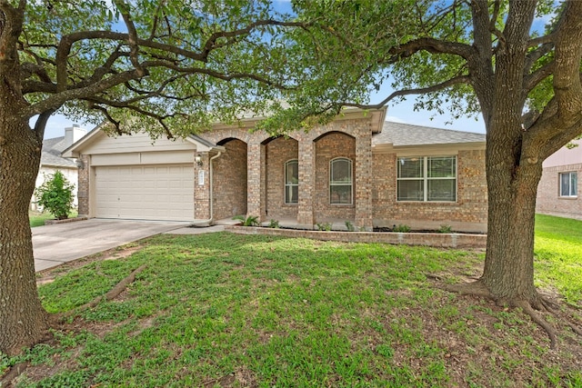 1612 Cora Marie Dr, Pflugerville, TX 78660 - view of front facade featuring a garage, brick siding, concrete driveway, and a front yard