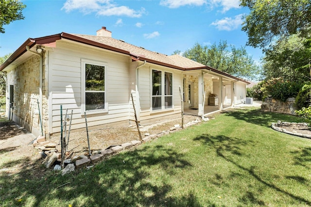 1403 Roaring Frk, Leander, TX 78641 - rear view of property featuring a chimney, a lawn, and stone siding