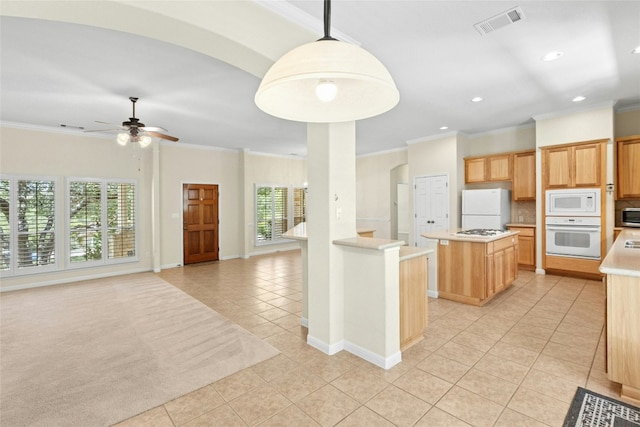 1403 Roaring Frk, Leander, TX 78641 - kitchen featuring white appliances, light tile patterned floors, crown molding, light countertops, and a center island
