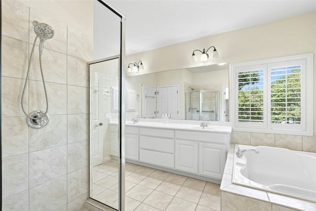 1403 Roaring Frk, Leander, TX 78641 - full bathroom featuring a stall shower, a garden tub, double vanity, and tile patterned floors