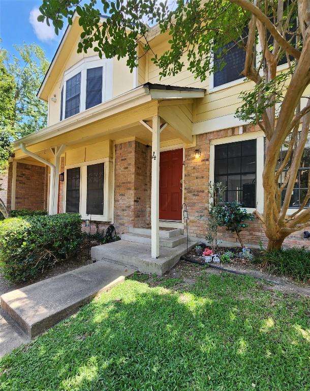 11901 Swearingen Dr Unit 4, Austin, TX 78758 - view of front of home featuring brick siding and a front yard