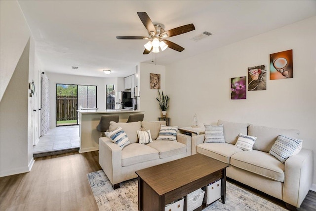 11901 Swearingen Dr Unit 4, Austin, TX 78758 - living room with wood finished floors and a ceiling fan