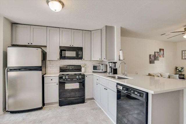 11901 Swearingen Dr Unit 4, Austin, TX 78758 - kitchen featuring black appliances, open floor plan, a peninsula, tasteful backsplash, and light countertops