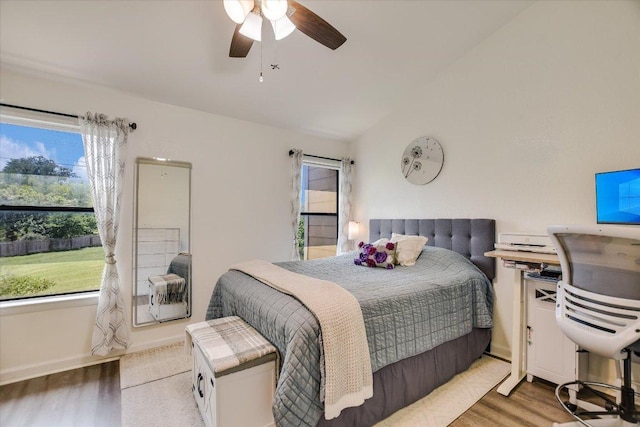 11901 Swearingen Dr Unit 4, Austin, TX 78758 - bedroom with vaulted ceiling, multiple windows, light wood-type flooring, and a ceiling fan