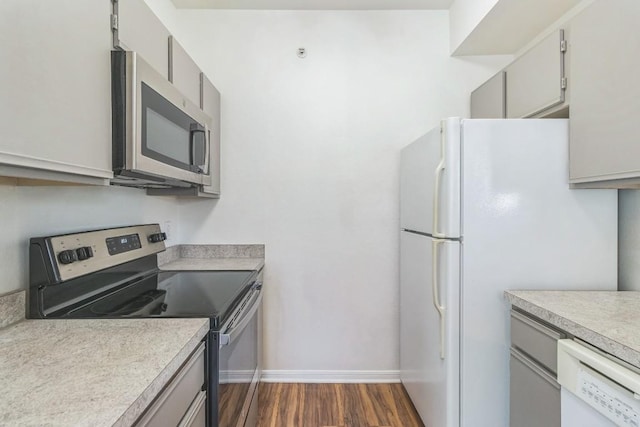 2320 Gracy Farms Ln Unit 522, Austin, TX 78758 - kitchen with appliances with stainless steel finishes, dark wood finished floors, light countertops, and gray cabinets