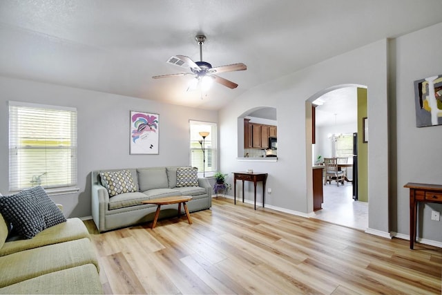106 Wild Plum, San Marcos, TX 78666 - living area featuring plenty of natural light, arched walkways, light wood-style floors, and vaulted ceiling