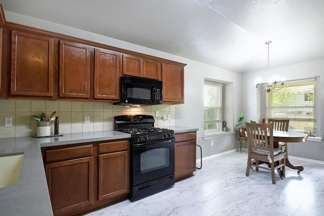 106 Wild Plum, San Marcos, TX 78666 - kitchen with black appliances, a chandelier, tasteful backsplash, decorative light fixtures, and light marble finish flooring