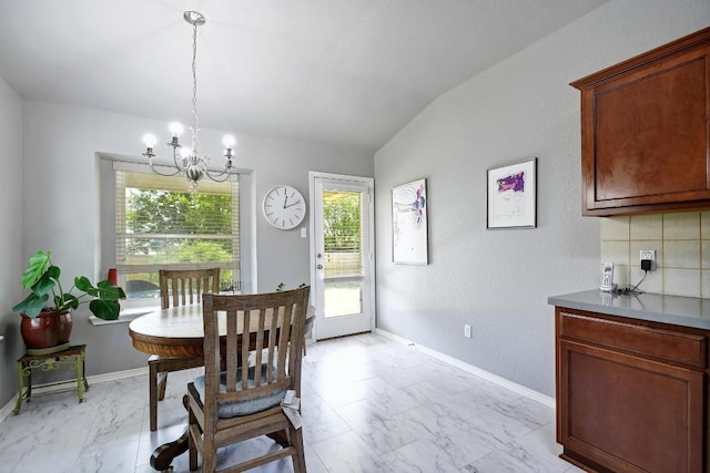 106 Wild Plum, San Marcos, TX 78666 - dining room featuring a chandelier, light marble finish floors, healthy amount of natural light, and lofted ceiling