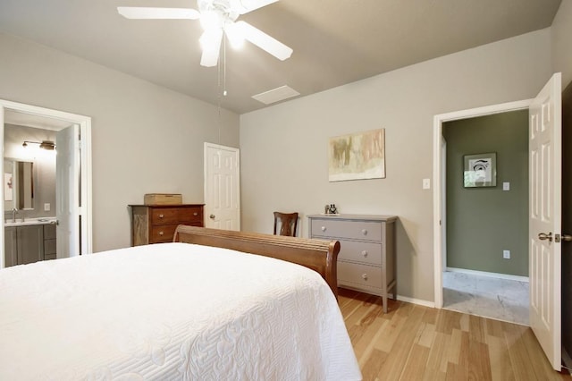 106 Wild Plum, San Marcos, TX 78666 - bedroom with light wood finished floors, ensuite bath, and ceiling fan
