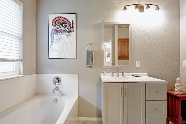 106 Wild Plum, San Marcos, TX 78666 - full bathroom featuring vanity, a garden tub, and a textured wall