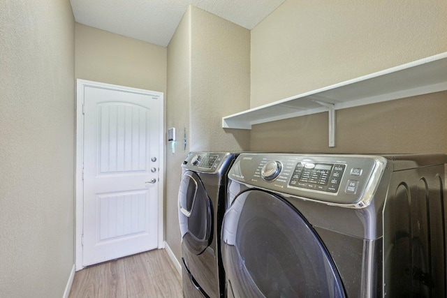 1124 Calla Lily Blvd, Leander, TX 78641 - laundry area with washer and dryer, wood finished floors, and a textured wall