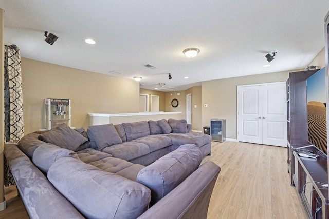 1124 Calla Lily Blvd, Leander, TX 78641 - living room with light wood-type flooring, wine cooler, and recessed lighting