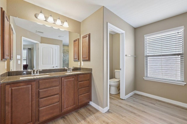 1124 Calla Lily Blvd, Leander, TX 78641 - bathroom featuring wood finished floors and double vanity