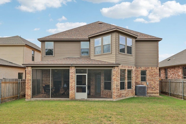 1124 Calla Lily Blvd, Leander, TX 78641 - back of house featuring brick siding, a sunroom, a fenced backyard, and roof with shingles