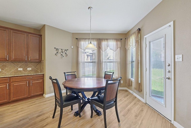 1124 Calla Lily Blvd, Leander, TX 78641 - dining space with light wood-style flooring and healthy amount of natural light