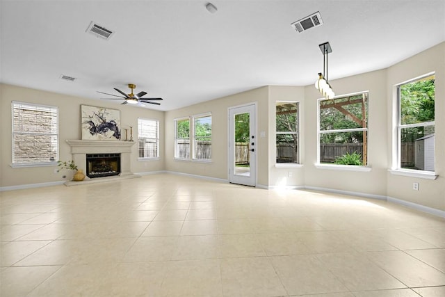 3528 Ruby Red Dr, Austin, TX 78728 - unfurnished living room with healthy amount of natural light, ceiling fan, light tile patterned floors, and a fireplace with raised hearth