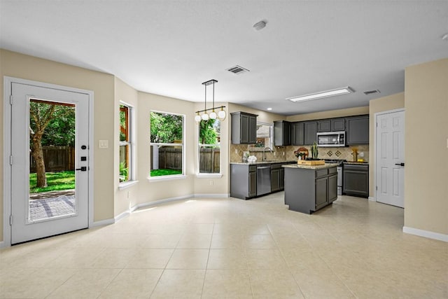 3528 Ruby Red Dr, Austin, TX 78728 - kitchen with stainless steel appliances, tasteful backsplash, plenty of natural light, and a kitchen island