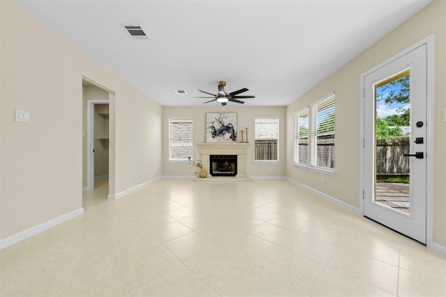 3528 Ruby Red Dr, Austin, TX 78728 - unfurnished living room with ceiling fan, light tile patterned flooring, and a fireplace with raised hearth