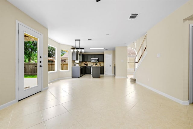 3528 Ruby Red Dr, Austin, TX 78728 - unfurnished living room with light tile patterned floors and stairway
