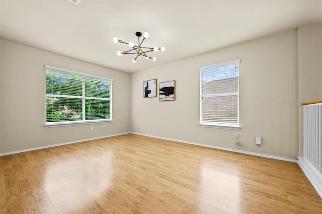 3528 Ruby Red Dr, Austin, TX 78728 - unfurnished room featuring a chandelier and light wood-style flooring