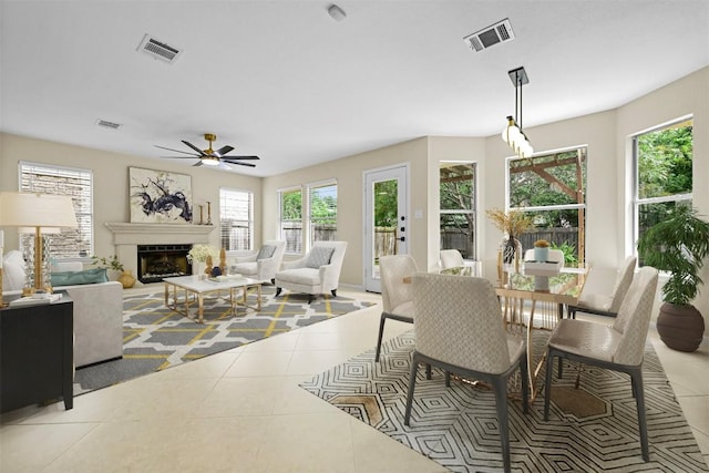 3528 Ruby Red Dr, Austin, TX 78728 - dining room featuring tile patterned floors, ceiling fan, and a fireplace