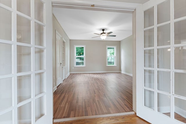 1414 E 4th St, Lampasas, TX 76550 - empty room with wood finished floors, french doors, and a ceiling fan