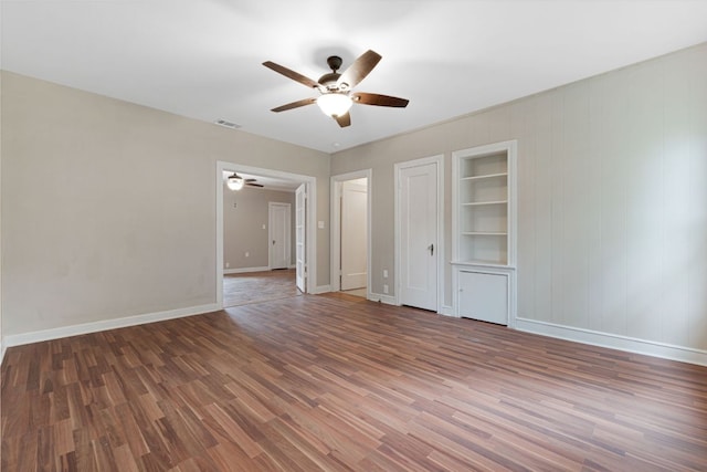 1414 E 4th St, Lampasas, TX 76550 - empty room featuring a ceiling fan, wood finished floors, and built in shelves