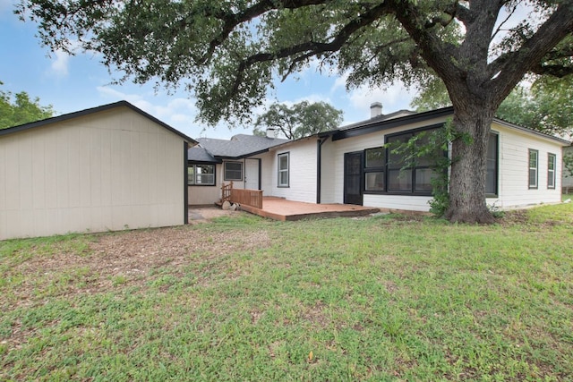 1414 E 4th St, Lampasas, TX 76550 - back of house with a wooden deck, a yard, and a chimney