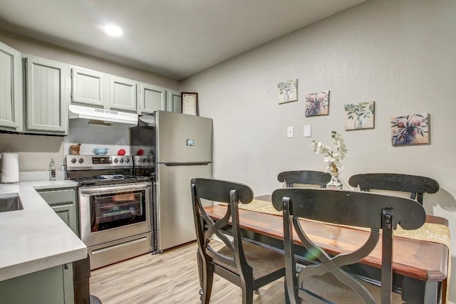 1624 Aquarena Springs Dr Unit B115, San Marcos, TX 78666 - kitchen featuring appliances with stainless steel finishes, under cabinet range hood, light countertops, and light wood finished floors